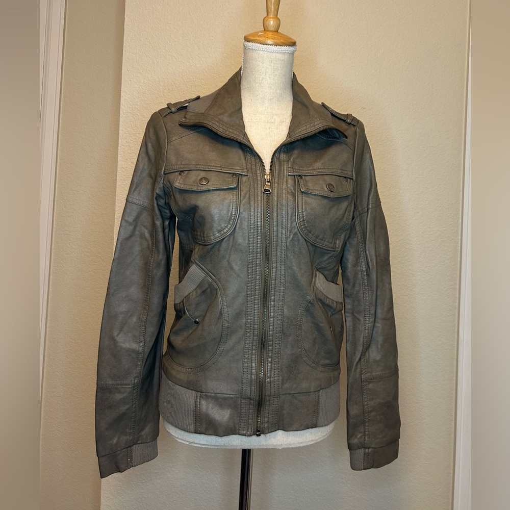 A woman’s Bernardo gray zip up leather jacket.
